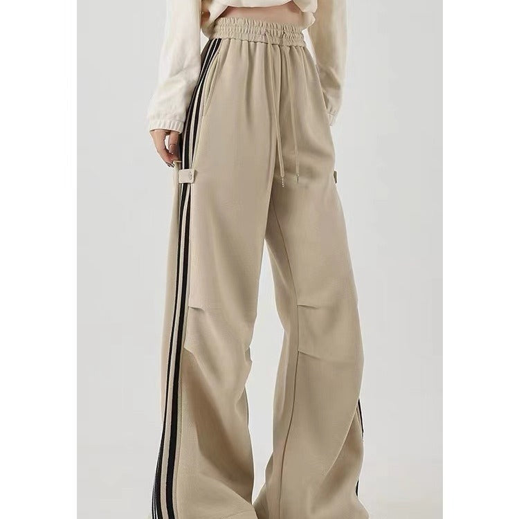 Wide-leg khaki cotton sweatpants featuring side pockets and a high waist design, perfect for summer workwear.